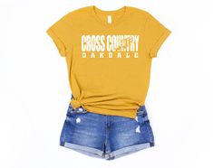 a t - shirt that says cross country on the front and shorts with holes at the bottom