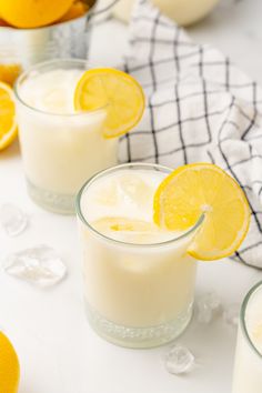 lemonade in glasses and pitcher with lavender sprigs on table cloth next to it