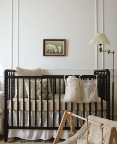 a baby's crib in the corner of a room with sheep on it