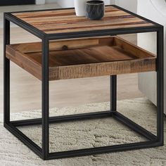 an end table with a wooden drawer and metal frame, on top of carpeted area