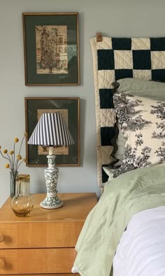 a bedroom with two pictures on the wall