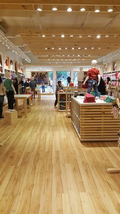 the inside of a shoe store with people shopping