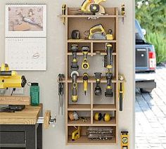 a workbench with tools hanging on the wall