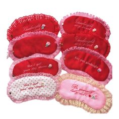 five red and pink eye masks with personalized messages on the front, along with polka dots