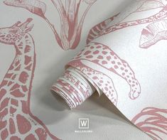 a giraffe wallpaper with pink and white designs on the back side of it