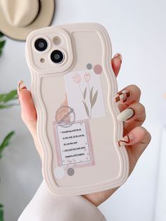 a woman holding up a phone case with an image on it