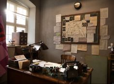 an old desk with many papers on it