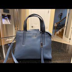 Kate Spade New York Blue Pebbled Grain Leather Shoulder Bag Handbag Zip Top To Secure Contents. 1 Compartment, Interior Lined In Matching Blue Poly Sateen Fabric W/ Kate Spade All Over It. Interior Rear Zip Pocket, Front Has 1 Open Slip Pocket. Handle Straps Have A 6” Drop. Exterior Has 2 Gold Loops To Attach The Detachable Pebble Grain Leather Shoulder Strap Which Has A Gold Buckle To Adjust The Length. Kate Spade Logo On Exterior Front In Gold. Measurements Are Approximent: H: 9”, W: 11.5”, D: Blue Satchel With Top Carry Handle For Everyday Use, Kate Spade Satchel With Detachable Strap For Everyday, Kate Spade Rectangular Satchel For Everyday Use, Rectangular Kate Spade Satchel For Everyday Use, Blue Handheld Satchel For Errands, Kate Spade Top Handle Satchel For Errands, Kate Spade Crossbody Satchel For Everyday, Blue Leather Satchel For Errands, Kate Spade Bag With Detachable Handle For Everyday Use