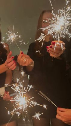 two women holding sparklers in their hands