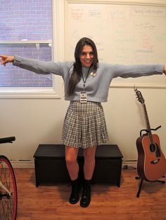 a woman standing in front of a whiteboard holding her arms out with both hands