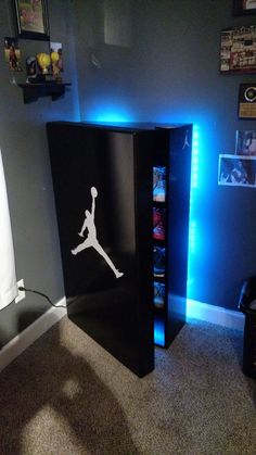 a black cabinet with a white jordan decal on the front and blue lights behind it