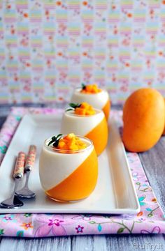 three oranges are sitting on a plate with spoons and utensils next to them