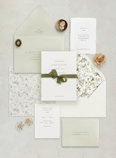 the wedding stationery is laid out on top of each other