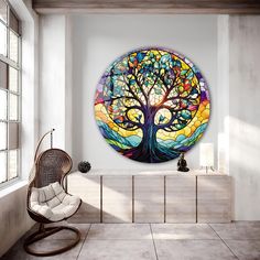 a room with a chair and a large stained glass tree on the wall above it