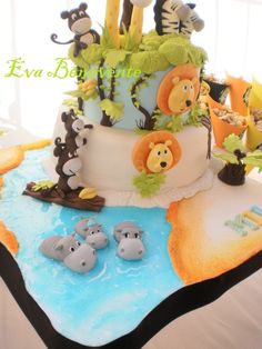 a baby shower cake decorated with animals and giraffes