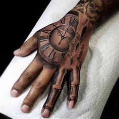 a person's hand with a tattoo on it and a clock in the middle