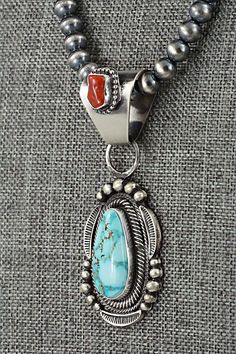 This stunning coral, natural Kingman turquoise and sterling silver necklace was made by Navajo silversmith Tom Lewis. The back is signed Tom Lewis and stamped sterling.Necklace: 19"Pendant Length: 2 1/2"Pendant Width: 1"Bead Size: 1/4" (6mm)Free shipping on all orders! We ship with USPS and always include tracking. All orders ship within a day of payment.Returns are accepted up to 30 days after you receive your order. Just send us a message. Our shop offers cash back or store credit. The item mu Moda Hippie, Spiny Oyster Jewelry, Vintage Native American Jewelry, Zuni Jewelry, Southwest Jewelry, Coral Turquoise