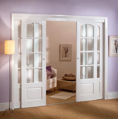 a living room with purple walls and white doors