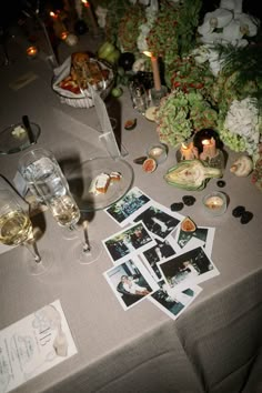 a table topped with pictures and wine glasses