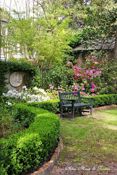 a wooden bench sitting in the middle of a garden