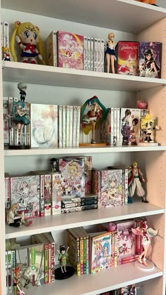 several shelves filled with various anime figurines and books on top of each shelf