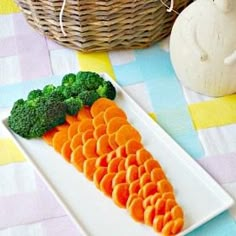 carrots and broccoli arranged on a white plate