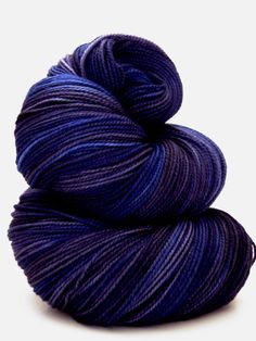 two skeins of yarn in blue and purple colors, on a white background