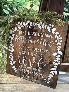 a wooden sign that says, these three remain both hope and love but the greatest love is love