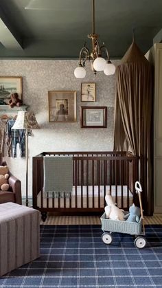 a baby's room with a crib, couch and chair