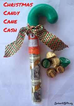 a christmas candy cane with money wrapped around it