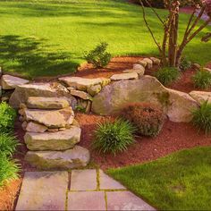 a stone path in the middle of a garden