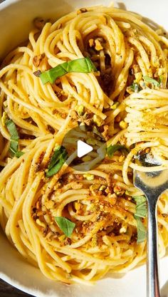 a white bowl filled with pasta and sauce