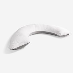 an image of a white pillow that is shaped like a curved piece of furniture on the floor