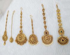 four different types of gold necklaces and earrings