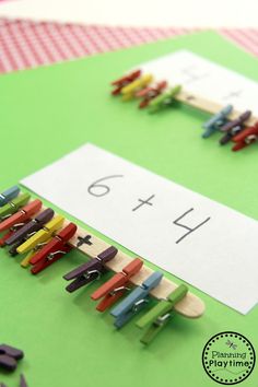 a green table topped with lots of clothes pins next to a white sign that says 4x4