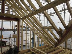 the inside of a house being built with wooden framing and roof trusss on top of it