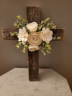 a wooden cross with flowers on it