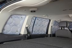 the interior of a car with four seats and no back doors, all folded up