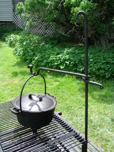 an outdoor grill with a pot on it