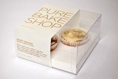 a white box that has some cupcakes inside of it and is open to show the packaging