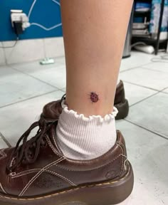 a person with a small tattoo on their ankle