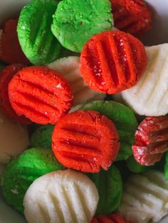 a bowl filled with different types of cream cheese mints