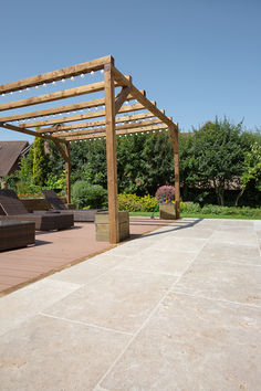 a wooden pergolan sitting on top of a patio