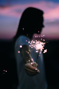 a person holding a sparkler in their hand