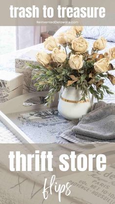 a vase filled with flowers sitting on top of a table next to books and magazines