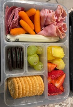 two plastic containers filled with food on top of a counter