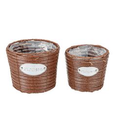 two brown wicker baskets with labels on the handles and sides, one is empty