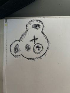 a drawing of a teddy bear with a cross on it