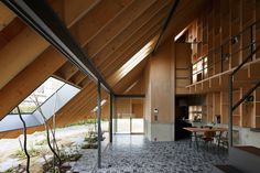 the interior of a building with wooden walls and flooring is made up of black and white tiles