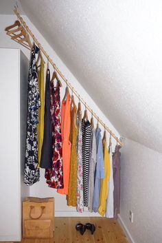 clothes are hanging up in an attic closet